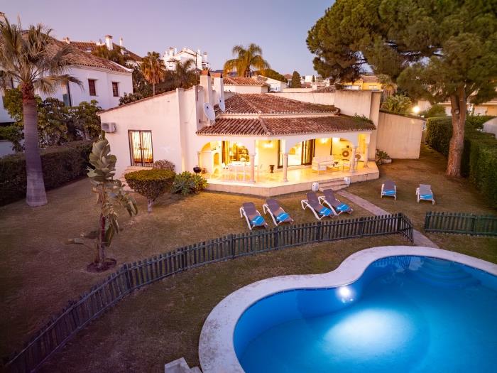 A beautiful green grass garden with pine trees surrounds the house and a 12x5m fenced pool