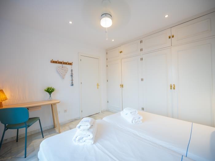 Two single beds, workdesk and spacious recessed wardrobes in master bedroom