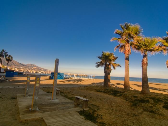 Sandy beach of Los Boliches with beach restaurants