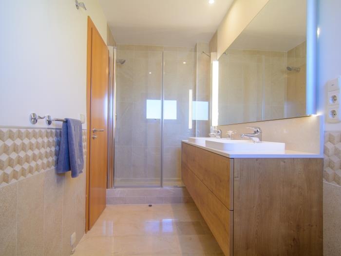 En suite bathroom with double sink,  walk in shower, bidet and toilet