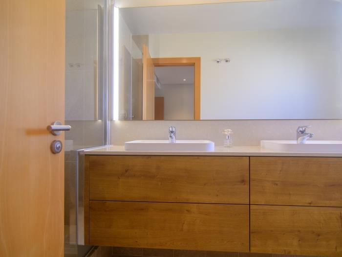 En suite bathroom with double sink,  walk in shower, bidet and toilet