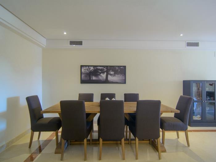 Dining area with eight sitter wooden table, comfortable chairs