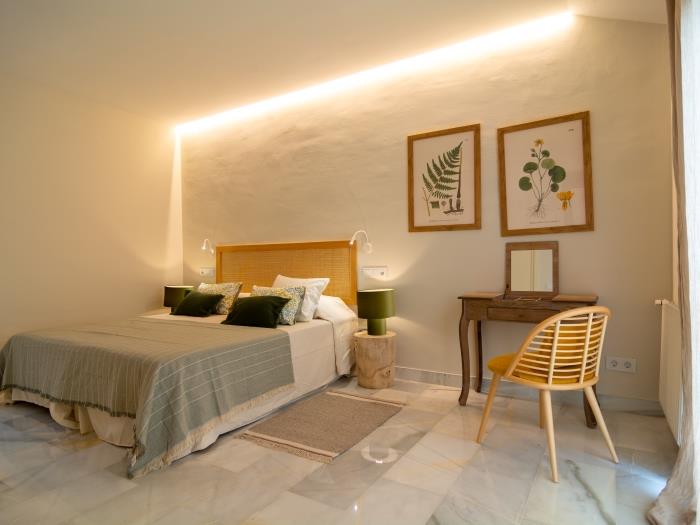 Two single beds in the bedroom on the upper level of the apartment with harmonious details