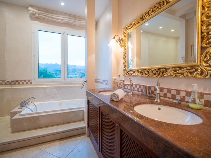 Bathroom with mountain views, bathtub, double sink, shower, toilet