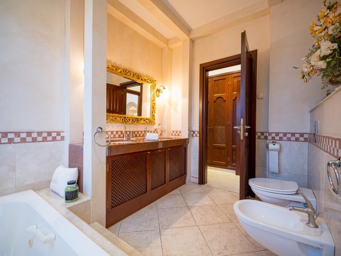 Elegant finishings in the bathroom with tub, shower, double sink, toilet and bidet