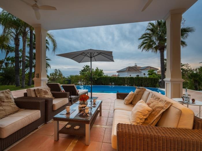 Spacious terrace with sea views and comfortable rattan sofa, armchairs and coffee table