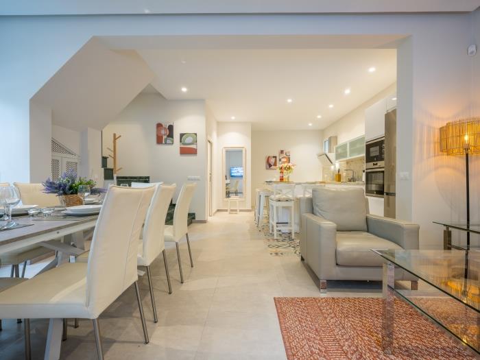 Living room with access to open plan kitchen with modern appliances