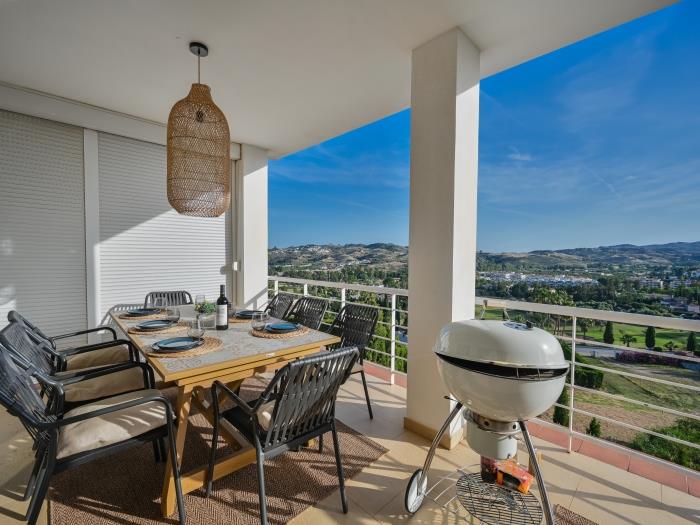Dining table for 8 and charcoal BBQ on terrace with mountainviews