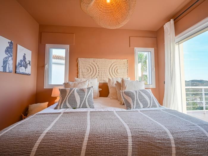 Bedroom with exit to spacious terrace with mountain views