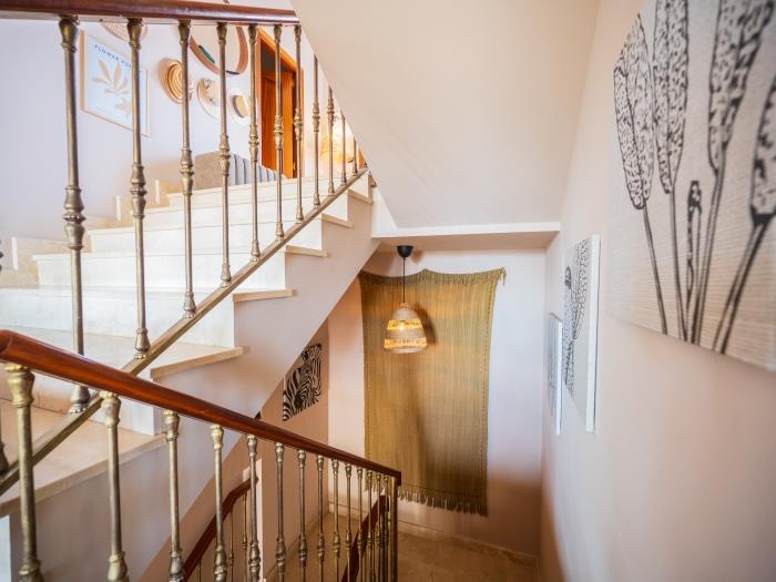 Elegant staircase with marble stairs connecting the three levels of the villa
