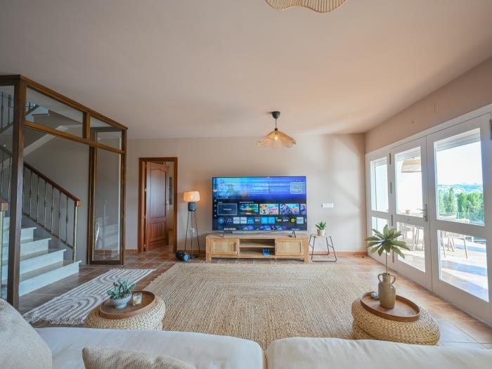 Spacious living room with exit to terrace and pool