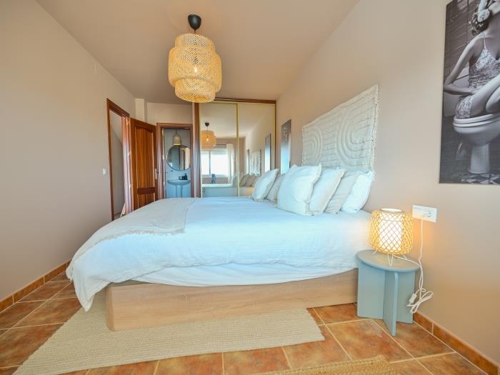 Bedroom with double bed and recessed wardrobe, en suite bathroom