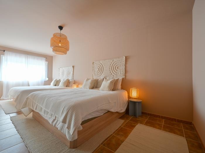 Double beds in bedroom with en suite bathroom