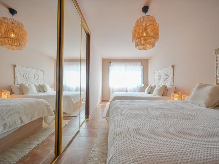 Bedroom with two double beds, wardrobe and en suite bathroom