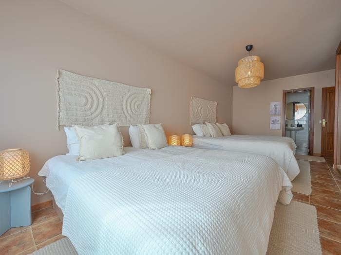 Bedroom with nightstands with lamps, wardrobe with mirrors and en suite bathroom