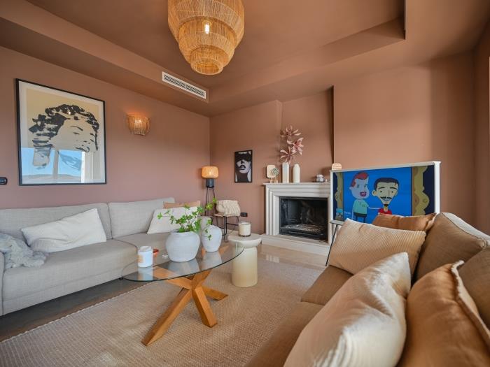 Comfortable sofas in living room with lounge area, TV and fireplace